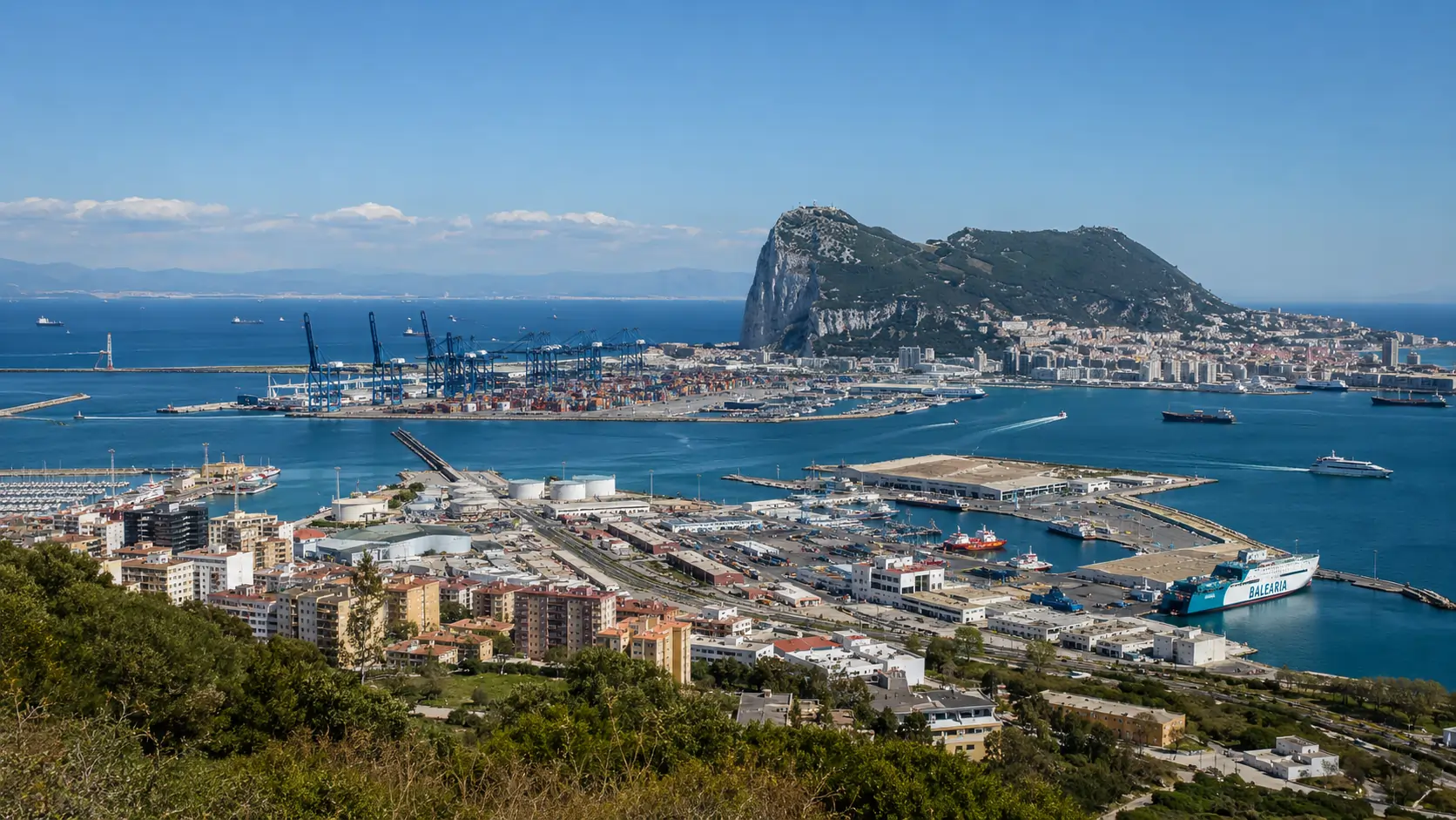 Panoramic view of the Port of Algeciras from the western hills with container terminals and the Rock of Gibraltar across the bay
